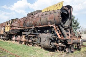 Old rusty crumbling locomotive in the abandoned station